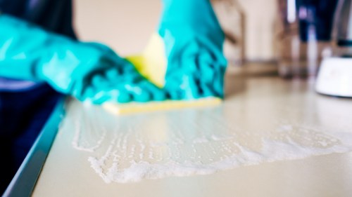 Cleaner preparing carpet care products before treatment